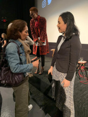 Agnes speaks with attendee after the panel